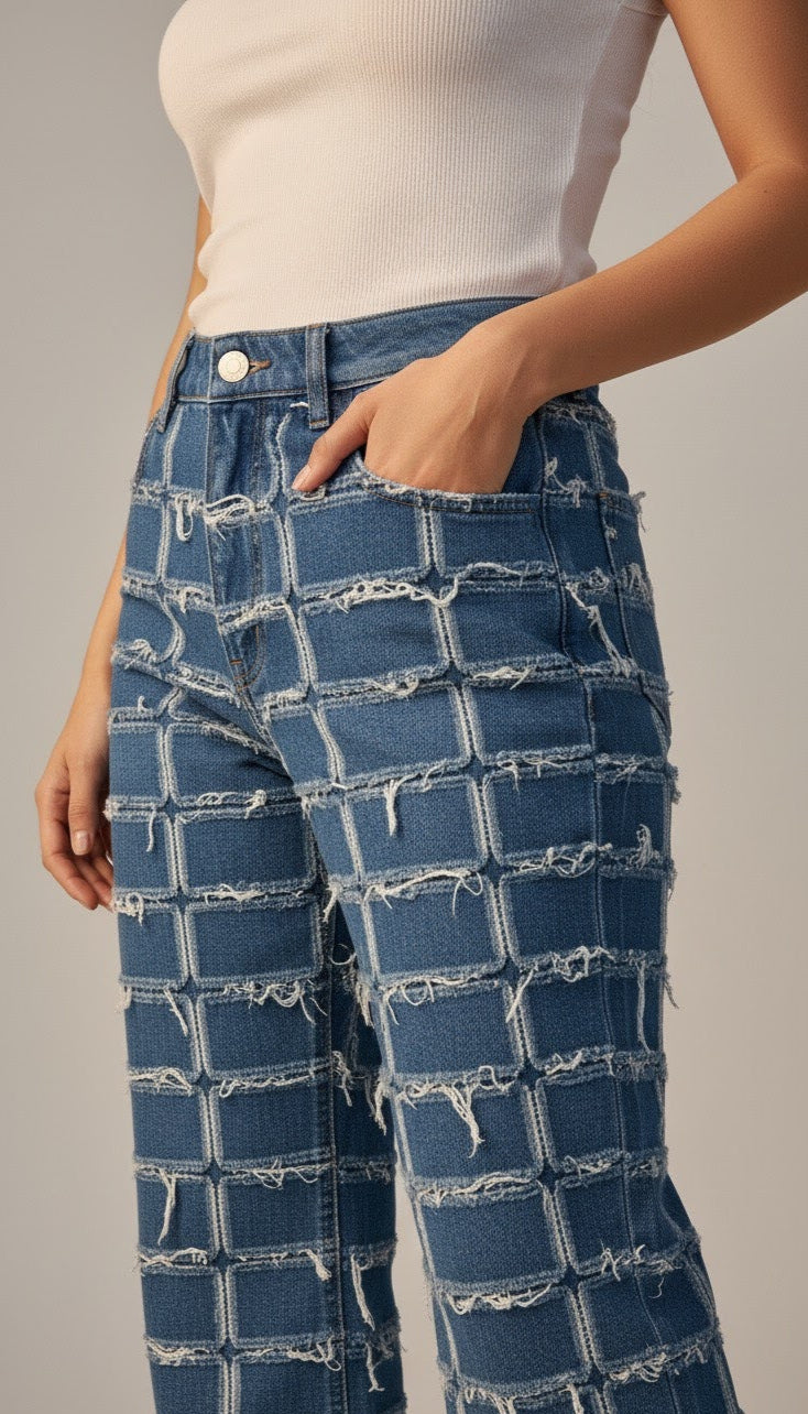 Person wearing blue checkered jeans with a plain background