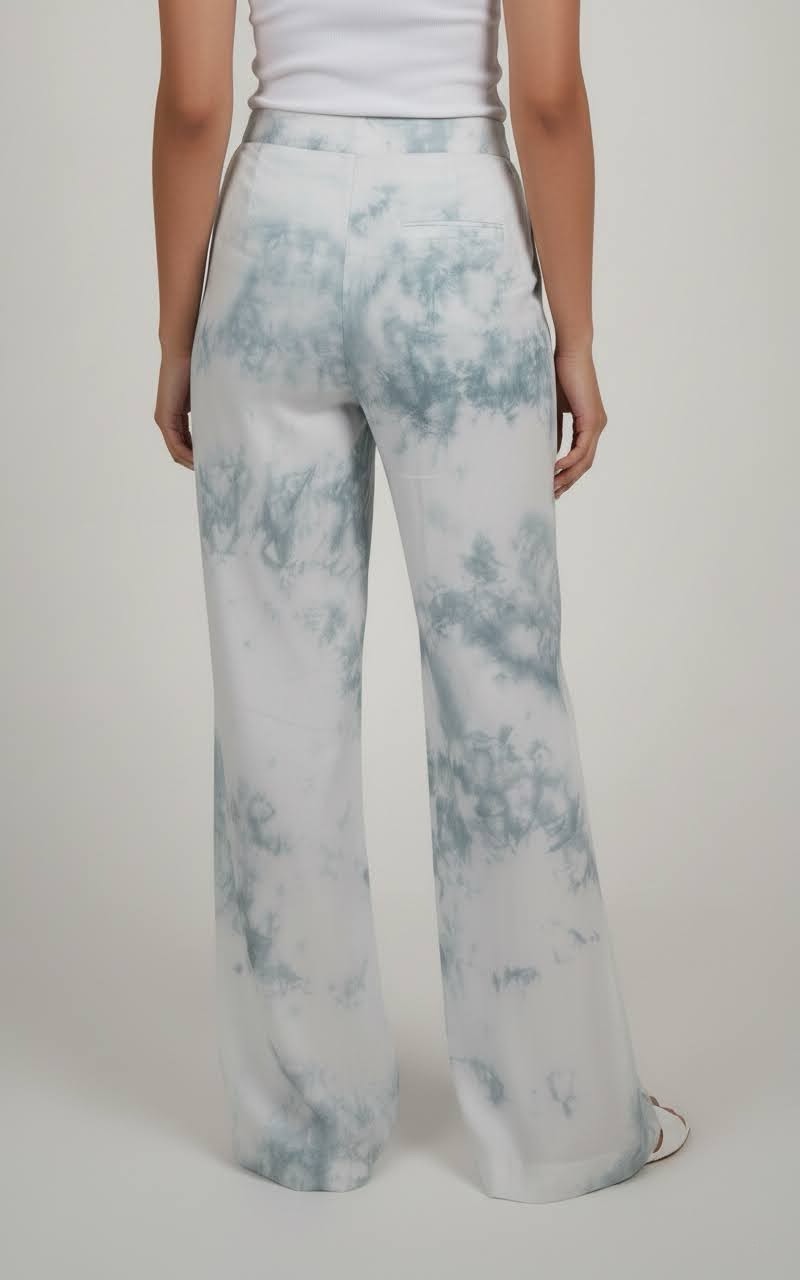 Tie-dye pants worn by a person on a white background