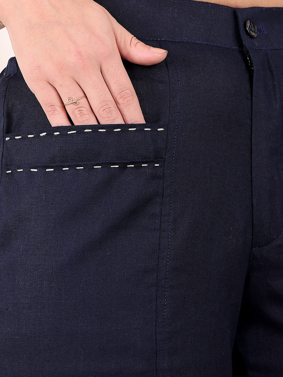 Navy blue pants with a hand touching the pocket