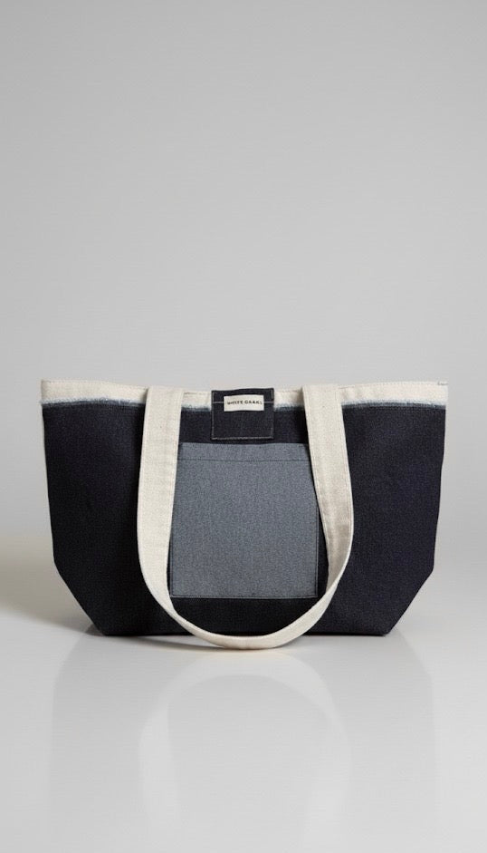 Two-toned tote bag with black and gray design on a white background