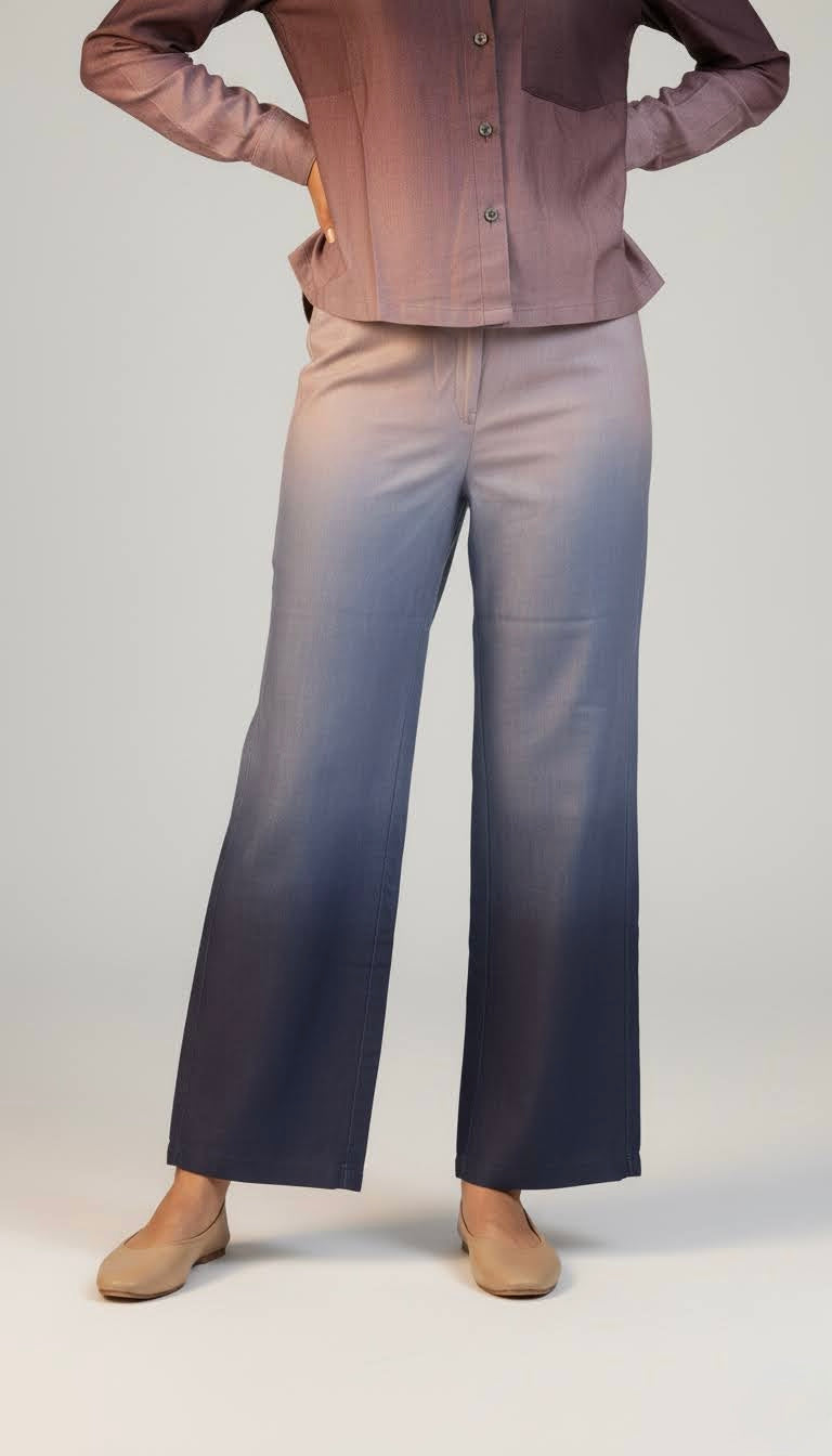 Person wearing a brown shirt and blue jeans on a plain background