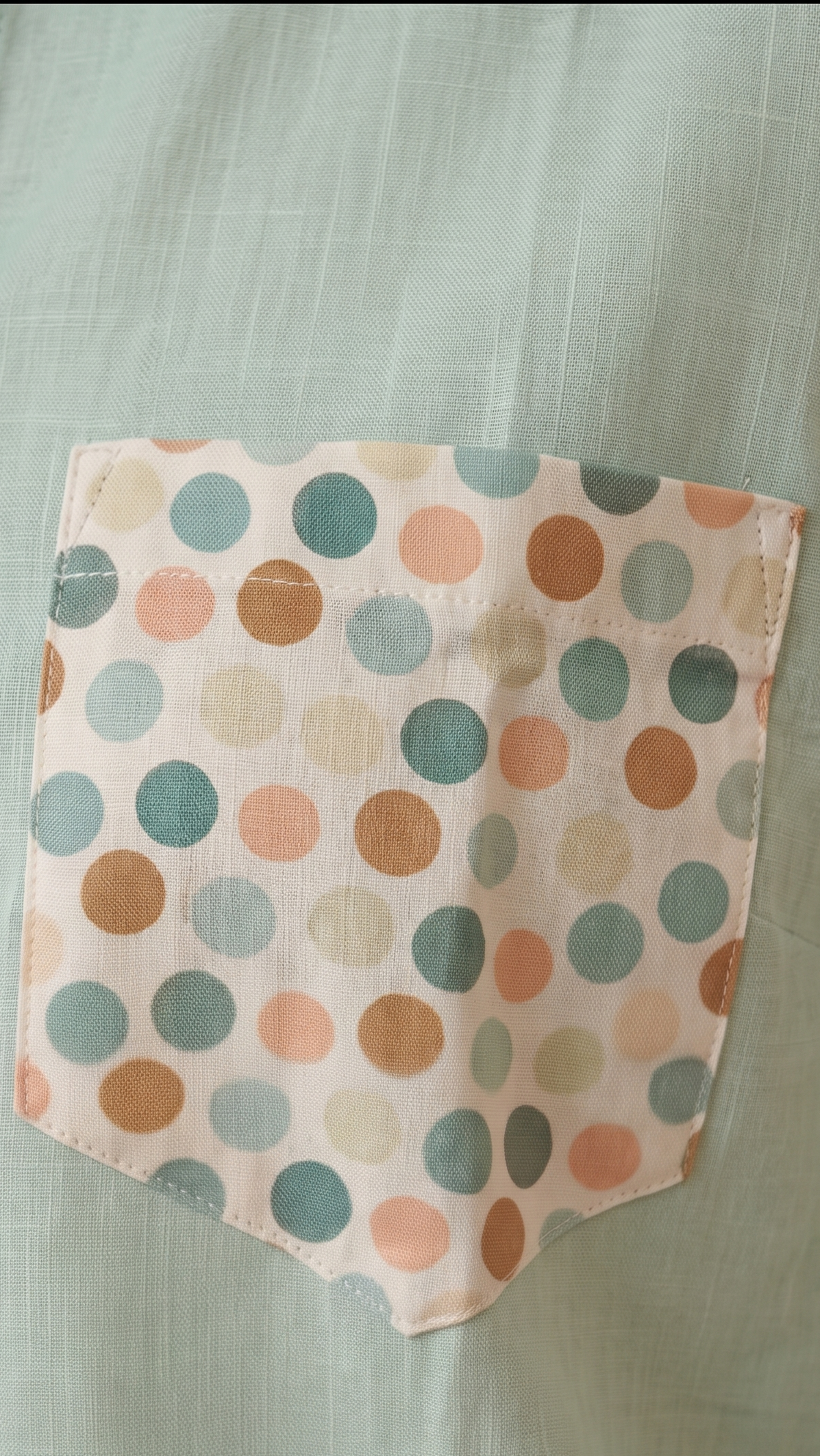Light green shirt with a polka dot pocket