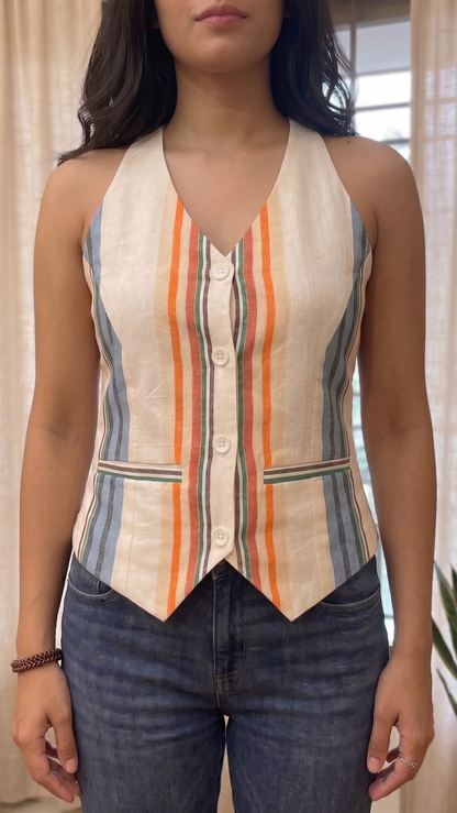 Person wearing a sleeveless striped top with a neutral background