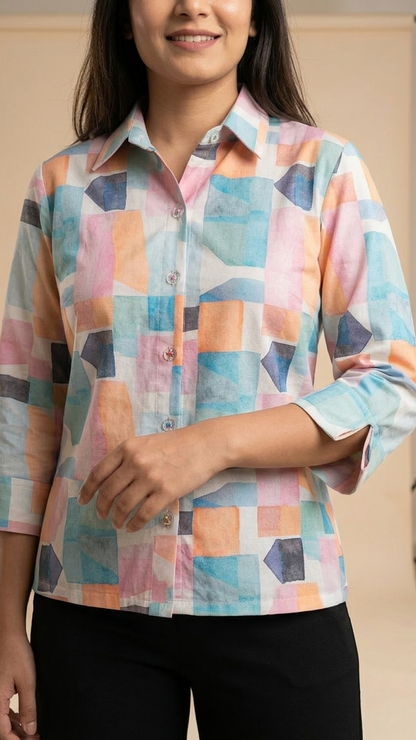 Woman wearing a colorful geometric patterned shirt against a neutral background