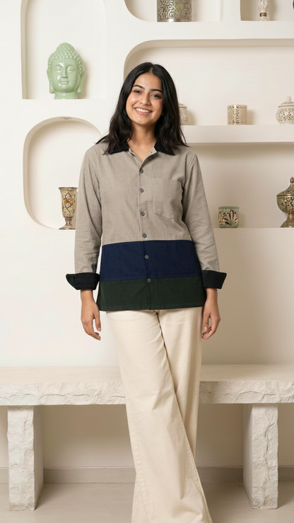 Woman wearing a layered shirt with a neutral background