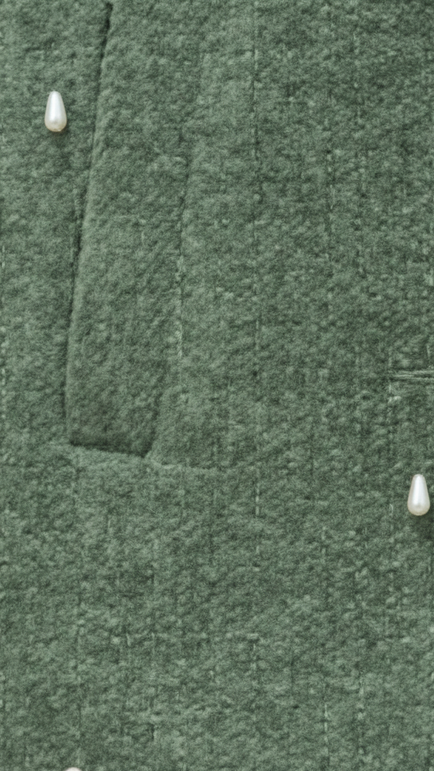 Close-up of a green textured fabric with buttons