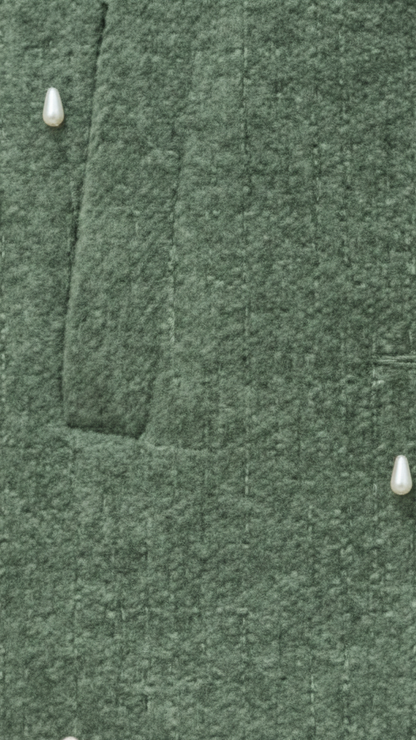 Close-up of a green textured fabric with buttons