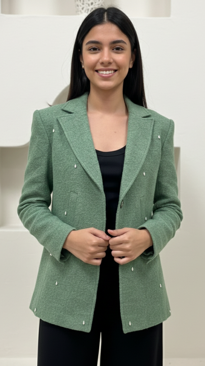 Woman wearing a green blazer against a white background