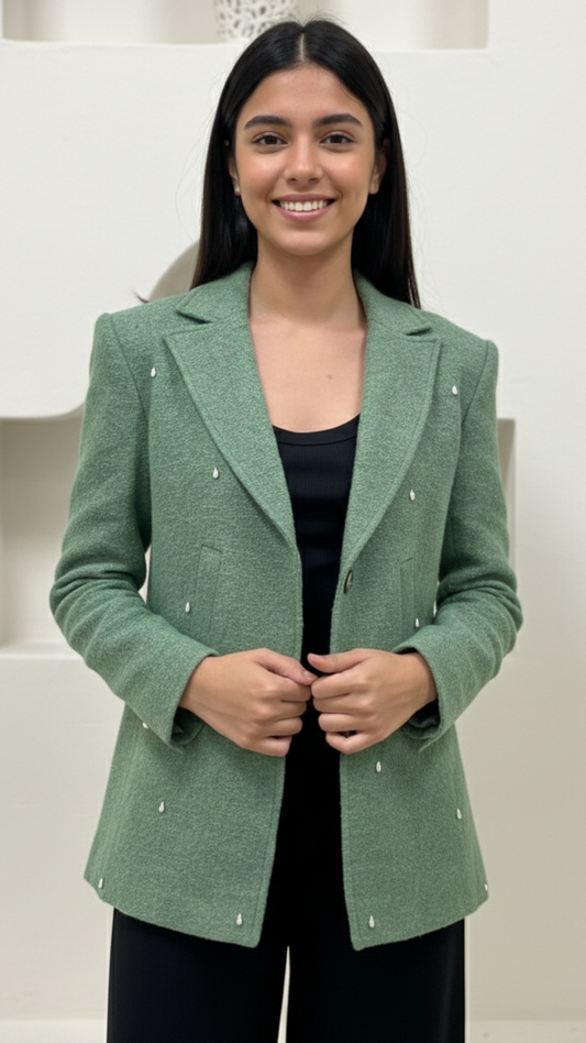 Woman wearing a green blazer against a white background