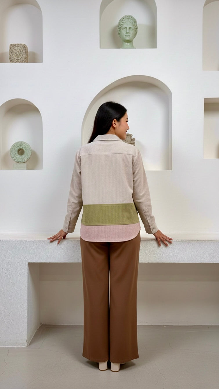Woman standing in a modern interior space with white walls and architectural elements.