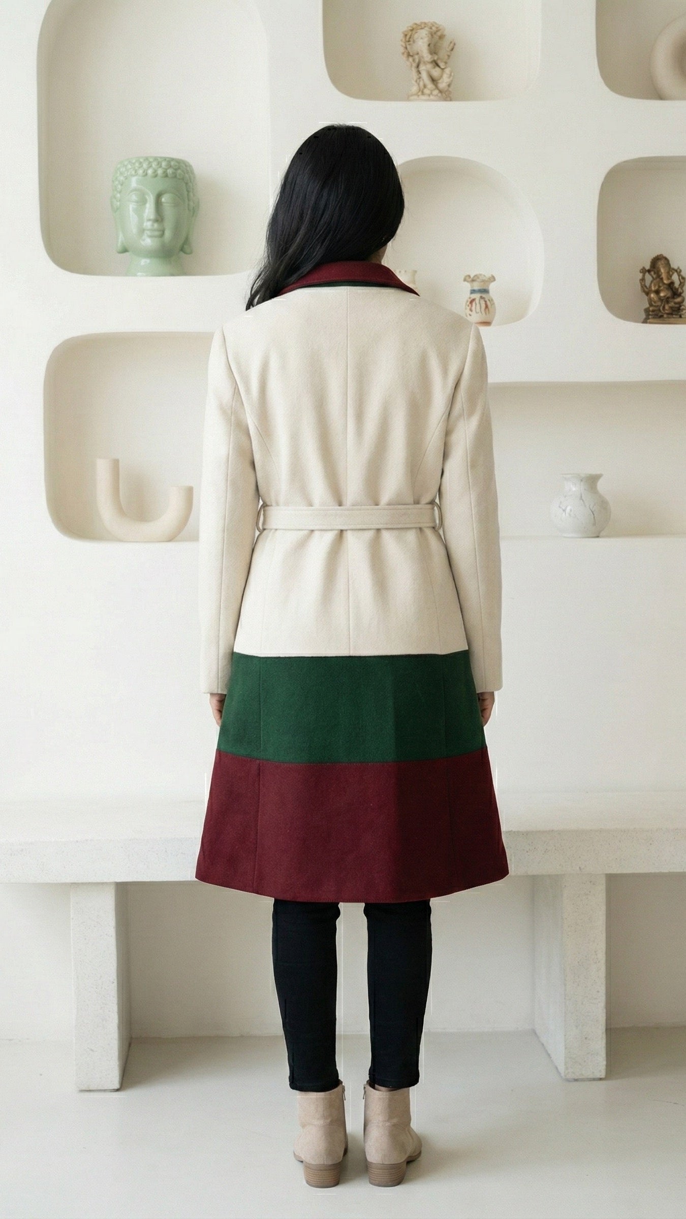 Person wearing a two-tone coat with a white and green background