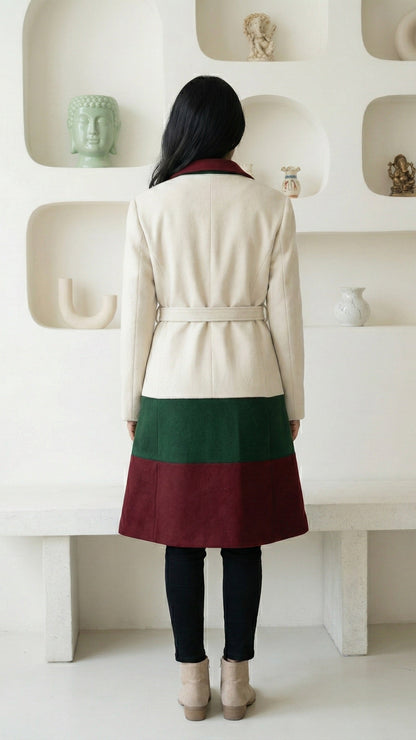 Person wearing a two-tone coat with a white and green background