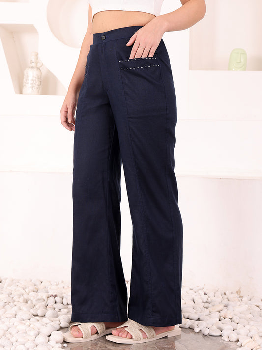 Navy blue pants worn by a person on a white background