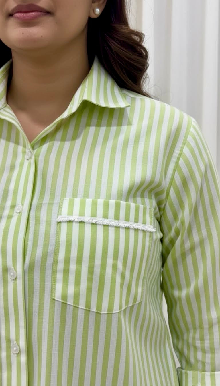 Close-up of a person wearing a green and white striped shirt with a pocket.